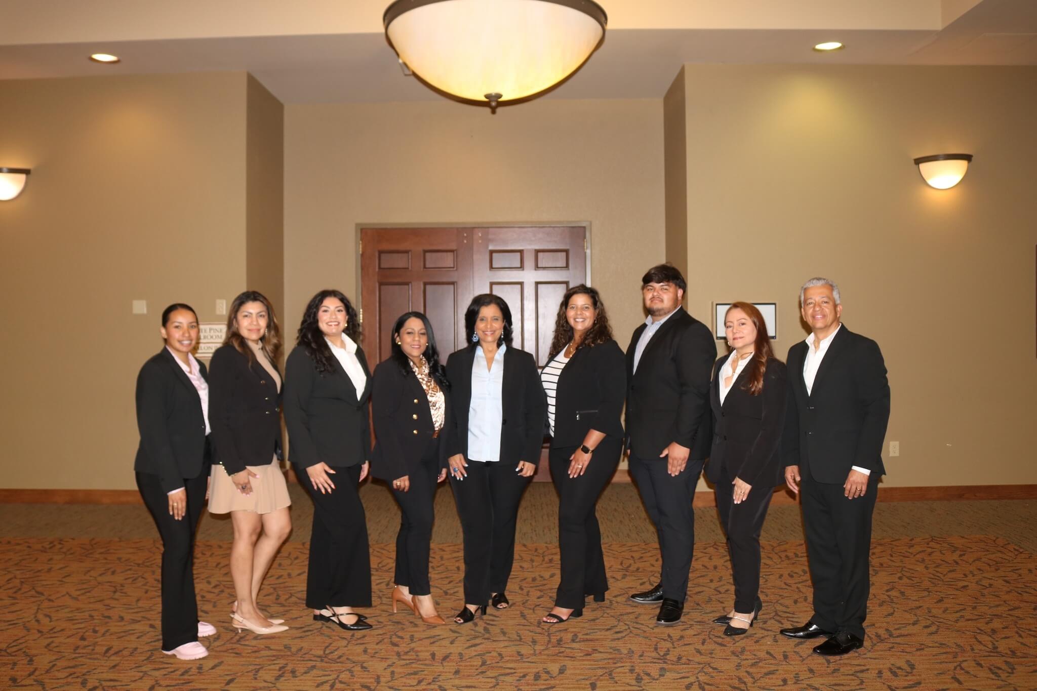 A group of nine people in suits.
